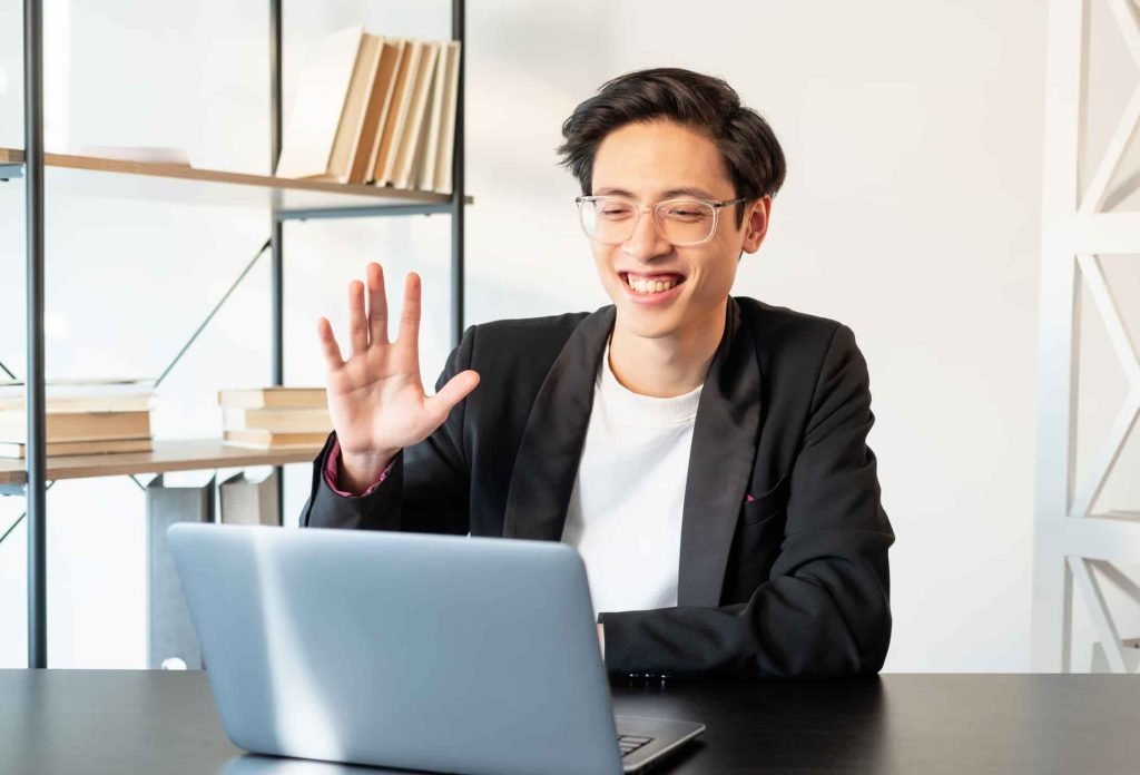 digital nomad attends business meeting on his laptop