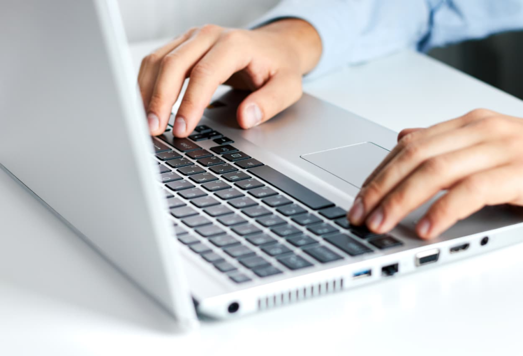 a person hiring a virtual assistant using his laptop