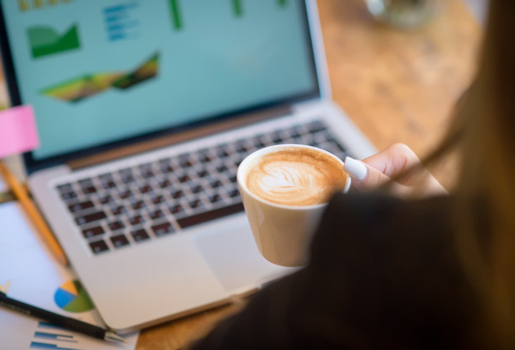 a woman enjoying her coffee while working on her laptop