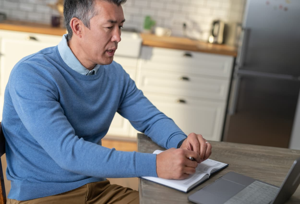 a patient talking to a virtual assistant on his laptop